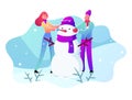 Young Man and Woman in Warm Clothing Making Snowman on Snowy Landscape Background. Winter Time Outdoor Holidays Activity Royalty Free Stock Photo