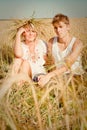 Young man and woman on wheat field Royalty Free Stock Photo