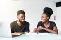 Young african man and woman working on laptop in business office Royalty Free Stock Photo