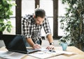 Young man work remote in his cool home office. Modern workspace studio for online business and freelance creative digital project