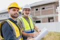 Young man worker construction engineer male working cooperate with senior project supervisor in construction site happy smile Royalty Free Stock Photo