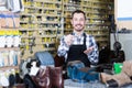 Young man worker displaying result of his key making Royalty Free Stock Photo