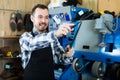 Young man worker honing his tools for repairing Royalty Free Stock Photo