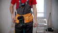 A young man worker wearing a tool belt Royalty Free Stock Photo