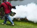 Young man worker are working fogging to eliminate mosquitoes