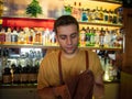 Young bartender cleaning cutlery