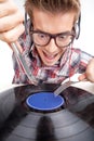 Young man working as dj with ear-phones and glasses. Royalty Free Stock Photo