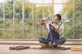 Young man working as handyman, assembling wood table with equipments, concept for home diy. Royalty Free Stock Photo