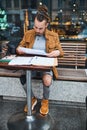 Young man working with documents in street cafe Royalty Free Stock Photo