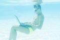 Young man working with his laptop underwater Royalty Free Stock Photo