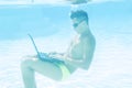 Young man working with his laptop underwater Royalty Free Stock Photo