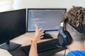 Young man working at home with his computer and headset, making a video call, explaining something Royalty Free Stock Photo