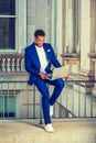 Young man working on laptop computer outside office building in New York City Royalty Free Stock Photo