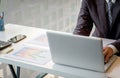 Young man working with laptop on his desk in office, man& x27;s hands Royalty Free Stock Photo