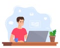 Young man working on laptop at home office. Freelancer at work, remote work. Young man sitting at a desk with a laptop and coffee Royalty Free Stock Photo