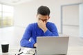 A young man working on a laptop. he`s angry and tired . on white isolated background