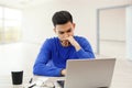 A young man working on a laptop. he`s angry and tired . on white isolated background