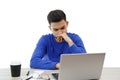 A young man working on a laptop. he`s angry and tired . on white isolated background