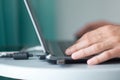 Young man working with laptop, man`s hands on notebook computer, business person at workplace Royalty Free Stock Photo