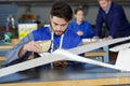 Young man working on model glider