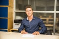 Young man working in an office at the desk looking Royalty Free Stock Photo