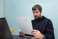 Young man working in the office with documents sitting at his desk. Business, training Royalty Free Stock Photo