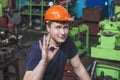 The young man working at the old factory on installation of equipment