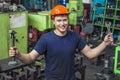 The young man working at the old factory on installation of equipment