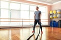 Young man working out with battle ropes at a gym Royalty Free Stock Photo