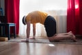 Young man working out at home, yoga, pilates, fitness training, in Cat yoga Pose Royalty Free Stock Photo