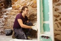 Young man working on plastering drywall at home renovation Royalty Free Stock Photo