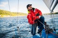 Young man working on sailing ship, active lifestyle, summer sport concept Royalty Free Stock Photo