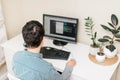 Young man working at a table with a computer on his working place. working at home. freelancer Royalty Free Stock Photo