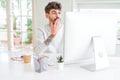 Young man working using computer cover mouth with hand shocked with shame for mistake, expression of fear, scared in silence,