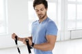 Young man during workout with a resistance bands in the gym Royalty Free Stock Photo