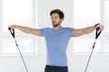 Young man during workout with a resistance bands in the gym Royalty Free Stock Photo