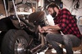Young man repairs a Motorcycle