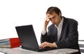 Young man works on laptop, close to breakdown Royalty Free Stock Photo