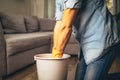 young man wringing out mopping cloth to clean the floor Royalty Free Stock Photo