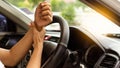 Young man with wrist pain driving long distance travel concept