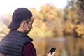Young man writes a message in an autumn park Royalty Free Stock Photo