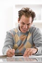 Young man writing at desk Royalty Free Stock Photo