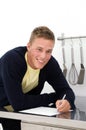 Young man writing down recipe