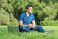 Young man writing in his sketchbook in city park Royalty Free Stock Photo