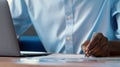 Young man writing in a notebook at the desk Royalty Free Stock Photo