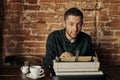 Young man writing on old typewriter. Royalty Free Stock Photo