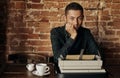 Young man writing on an old typewriter. Royalty Free Stock Photo