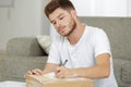 young man writing postage label for parcel Royalty Free Stock Photo