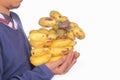 Young man& x27;s hand holding bananas in clusters on a white background. Fruit cluster concept. negative space Royalty Free Stock Photo