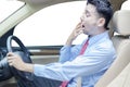 Young man yawning in car Royalty Free Stock Photo